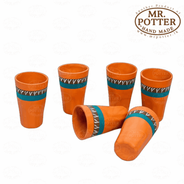 Colorful handcrafted ceramic mugs with orange glaze and decorative blue and black bands.