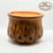 Handcrafted wooden candle holder with intricate traditional design.