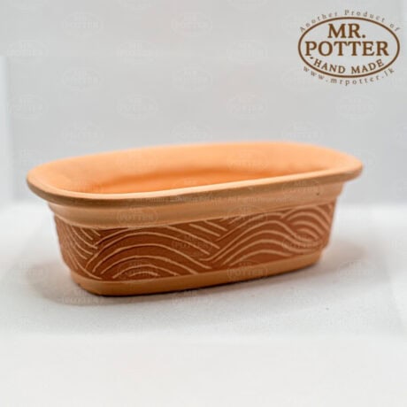 Handmade terracotta flowerpot with carved wave design, ideal for garden plants and home decor.