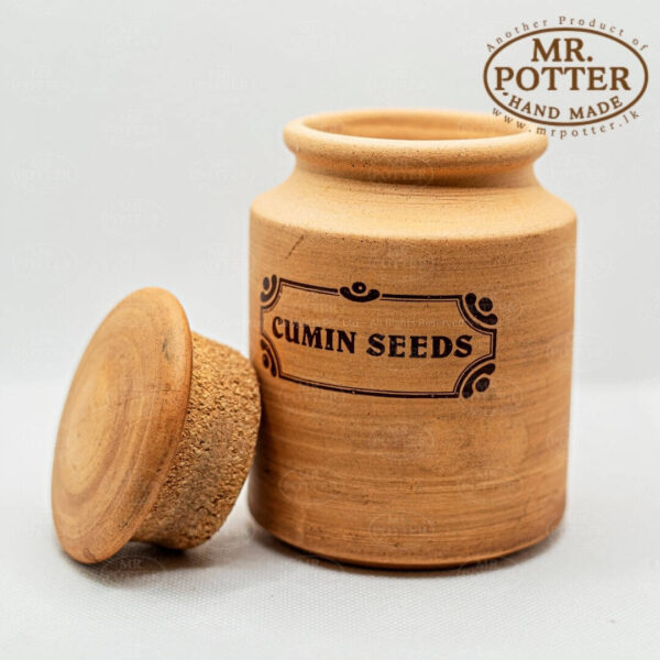 Organic cumin seeds in hand-crafted ceramic jar, excellent for kitchen storage and spice collection.