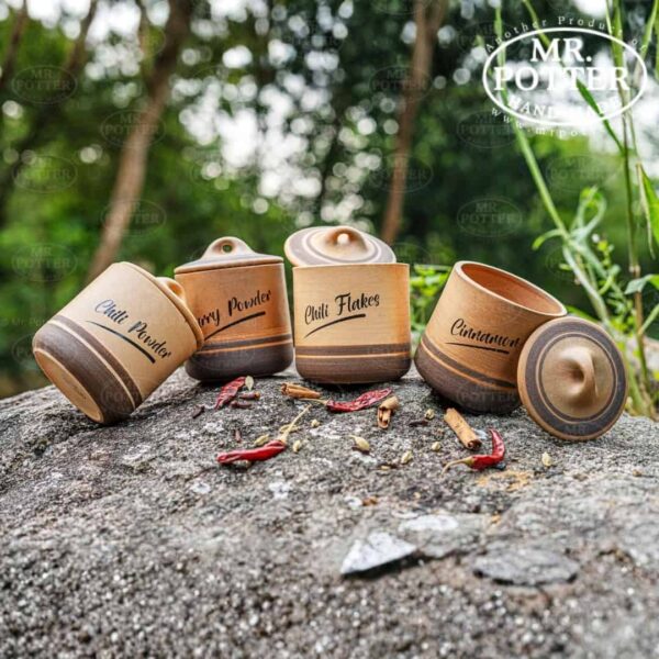 Vintage spice jars with natural wood finish, labeled for chili powder, chili flakes, and cinnamon.