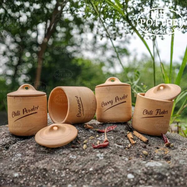 Natural wooden spice jars with labeled lids for chili powder, curry powder, and chili flakes, ideal for kitchen storage.